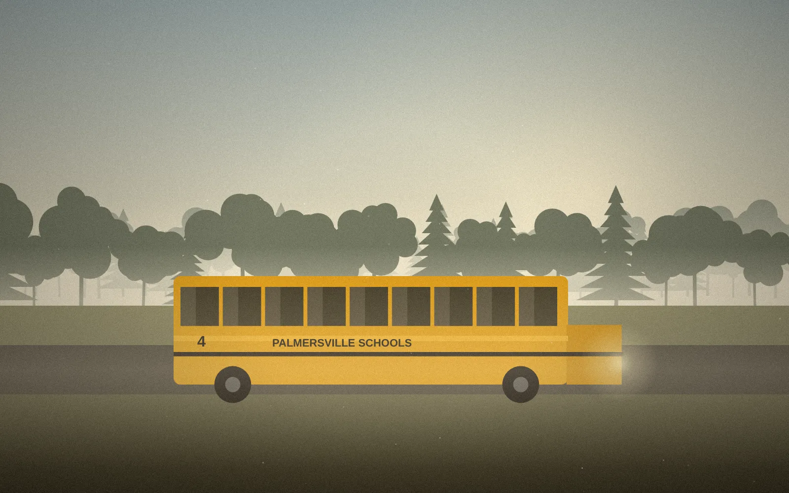 A yellow school bus on a misty country road at morning